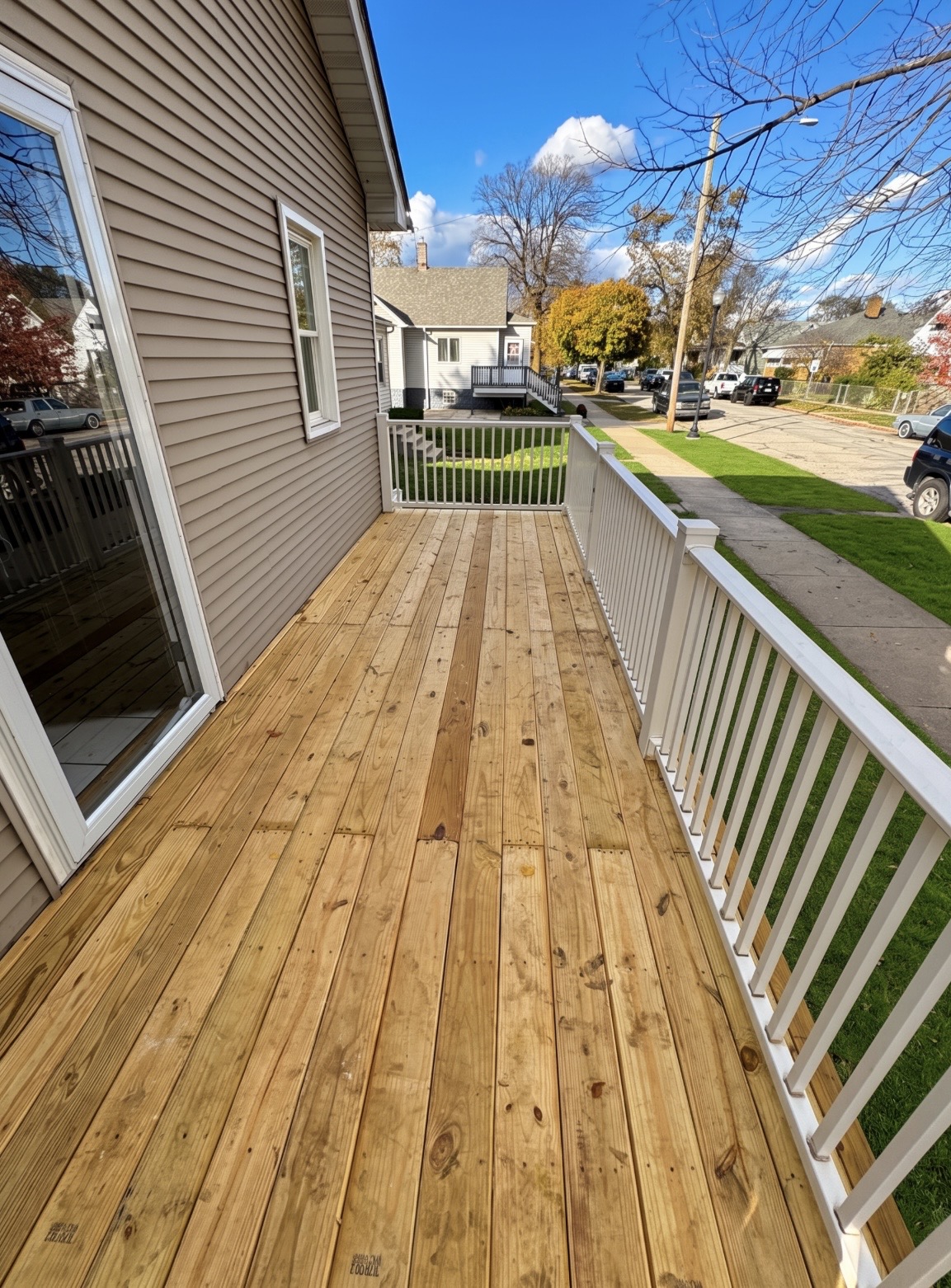Pressure treated deck with white vinyl railing
