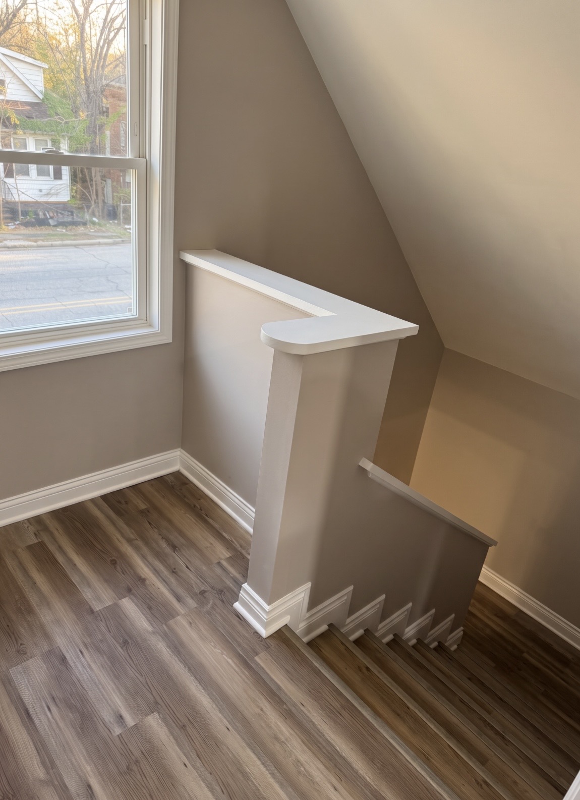 Interior stairwell with new trim, paint and vinyl plank flooring